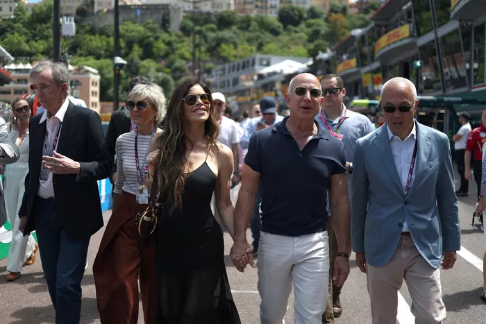 Derek Chang, Chief Executive Officer of Liberty Media Corporation, Jeff Bezos and Lauren Sanchez on the grid