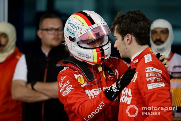 Sebastian Vettel, Ferrari, talks to his team mate Charles Leclerc, Ferrari, 3rd position, after the race