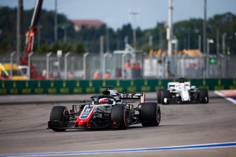 Romain Grosjean, Haas F1 Team VF-18, leads Marcus Ericsson, Sauber C37