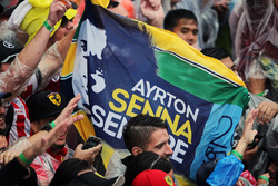 A Ayrton Senna banner with fans at the podium