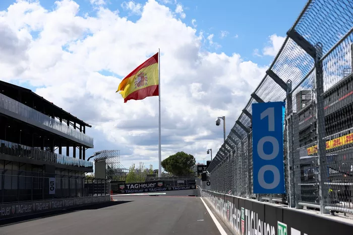 A Spanish flag flies over the circuit