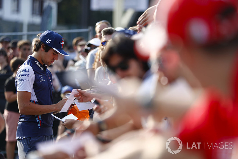 Lance Stroll, Williams Racing, signs autographs for fans