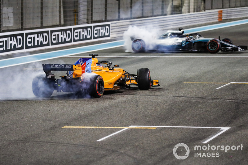 Fernando Alonso, McLaren MCL33, e Lewis Hamilton, Mercedes AMG F1 W09 EQ Power+, eseguono dei donuts alla fine della gara