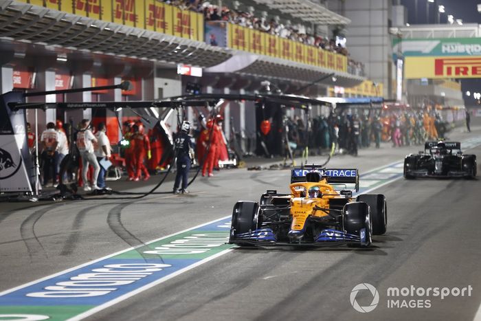 Daniel Ricciardo, McLaren MCL35M, y Sebastian Vettel, Aston Martin AMR21, en el pit lane