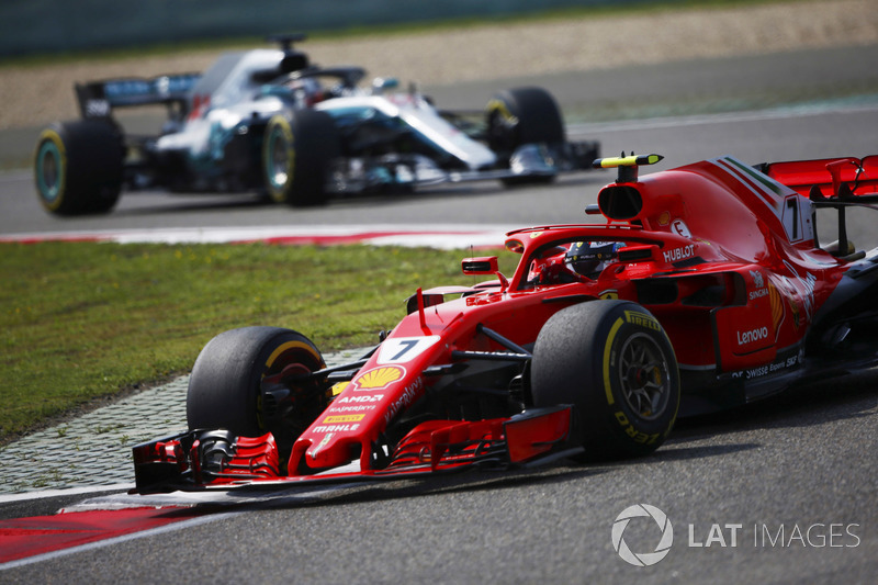 Kimi Raikkonen, Ferrari SF71H, leads Lewis Hamilton, Mercedes AMG F1 W09