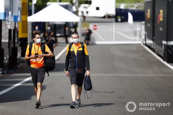 McLaren team members arrive in the paddock