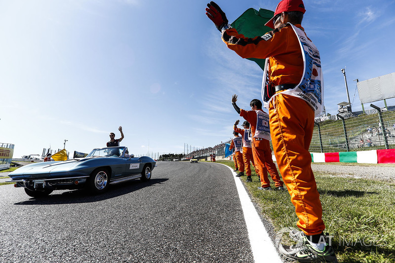 Marshals line the track as Romain Grosjean, Haas F1 Team, passes in the drivers parade