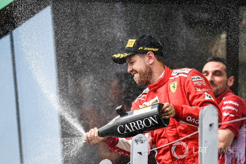 Race winner Sebastian Vettel, Ferrari celebrates on the podium with the champagne