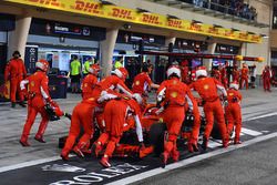 The car of Kimi Raikkonen, Ferrari SF71H is pushed back to the pit