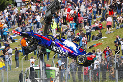 The damaged Pierre Gasly Toro Rosso STR13 is craned off the circuit