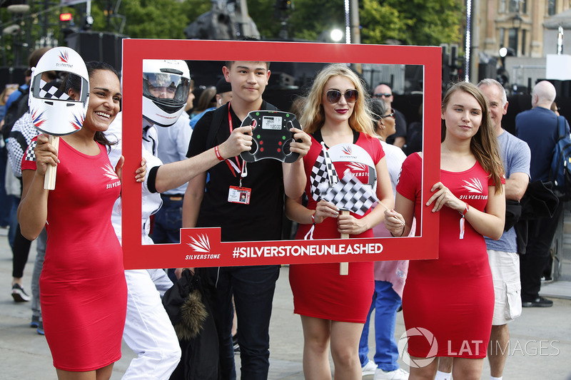 A young fan has his photo taken, some Grid Girls