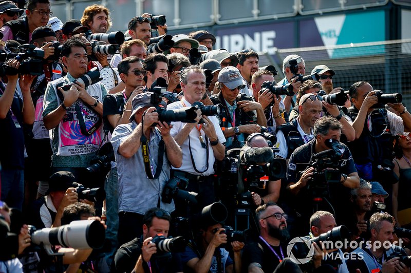 Photographers and cameramen gather on the grid