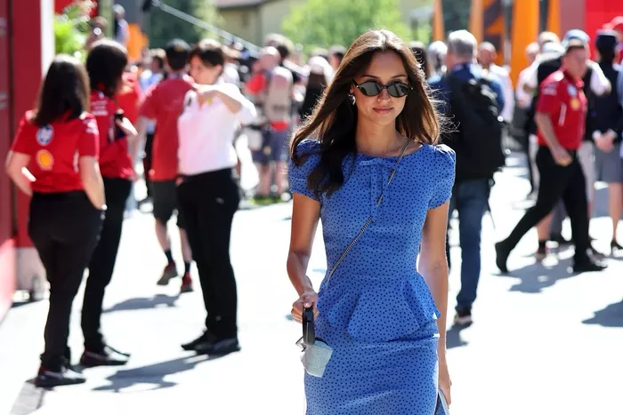 Alexandra Saint Mleux walks in the Paddock with Leo Leclerc 