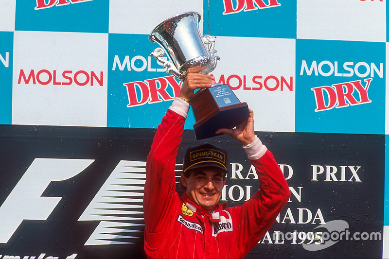 Jean Alesi, 1st position, celebrates his maiden Grand Prix win on the podium