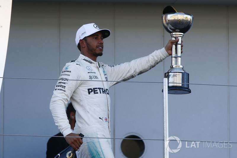 Race winner Lewis Hamilton, Mercedes AMG F1, leaves the podium with his trophy