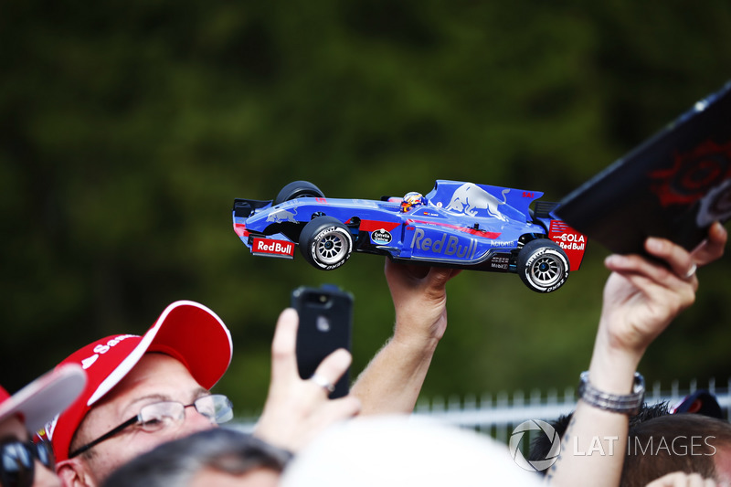 A Carlos Sainz Jr., Scuderia Toro Rosso, fan, displays a model