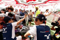 Felipe Massa, Williams, and Lance Stroll, Williams, sign autographs for fans