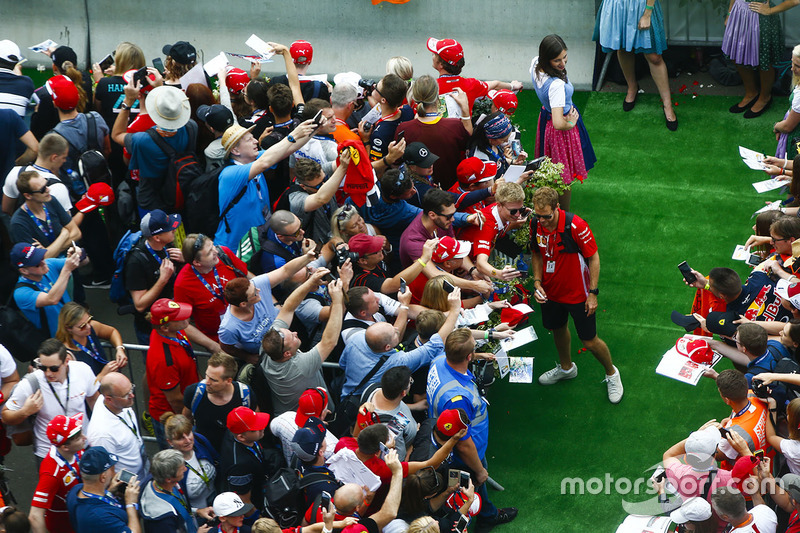 Sebastian Vettel, Ferrari, has his photo taken with a fan