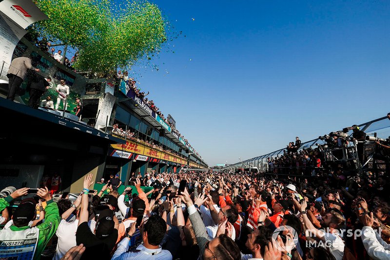 A crowd gathers as the podium ceremony concludes
