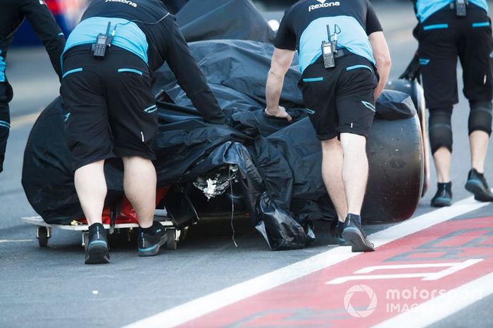 Crashed Car of Robert Kubica, Williams FW42 being pushed by mechanics back to the garage