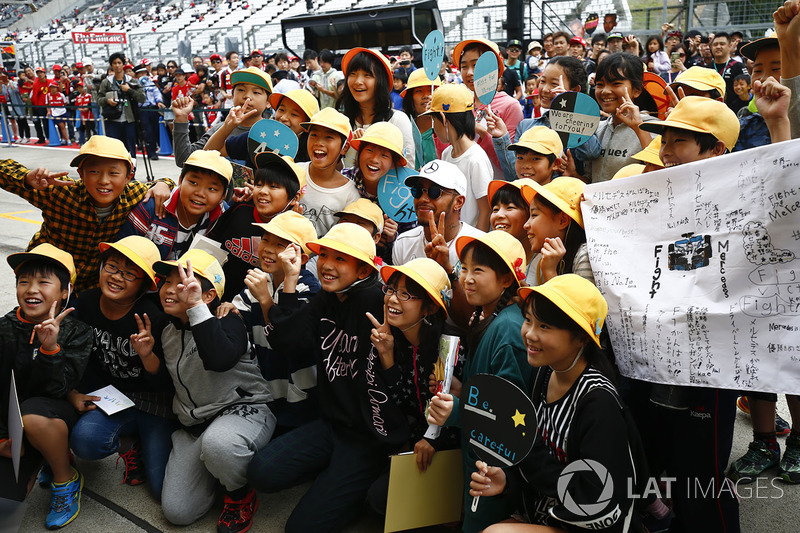 Lewis Hamilton, Mercedes AMG F1, meets some fans in the pit lane