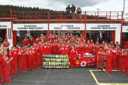 Michael Schumacher, Ferrari F2004 celebrates with the Ferrari team after winning his 7th world champ