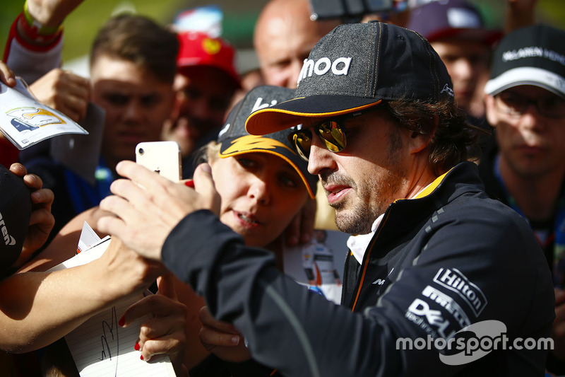 Fernando Alonso, McLaren, signs autographs for fans
