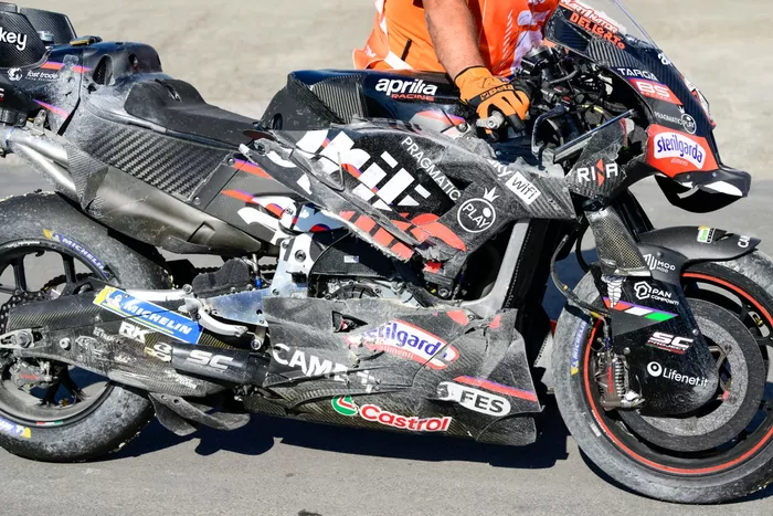  A crashed Factory Racing Aprilia is pushed back to the paddock.