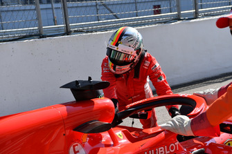 Sebastian Vettel, Ferrari pushes his car back in the pit lane