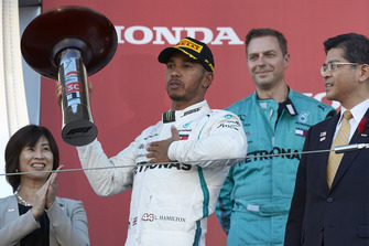 Lewis Hamilton, Mercedes AMG F1, celebrates his win on the podium with his trophy