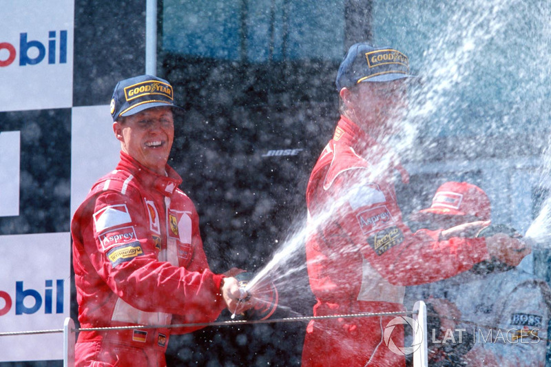 Podium: winner Michael Schumacher, Ferrari, second place Eddie Irvine, Ferrari, third place Mika Hakkinen, McLaren