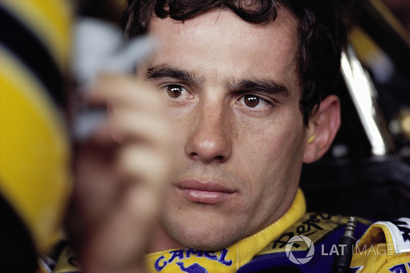 Ayrton Senna strapped to his Lotus cockpit