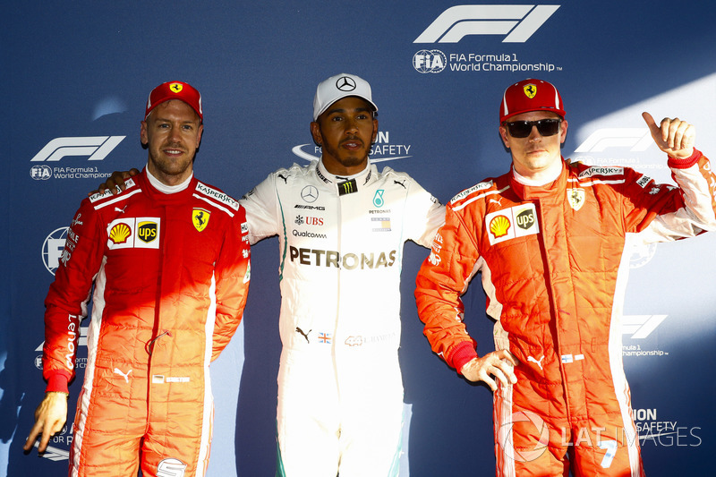 Lewis Hamilton, Mercedes AMG F1, celebrates taking pole position between Kimi Raikkonen, Ferrari, an