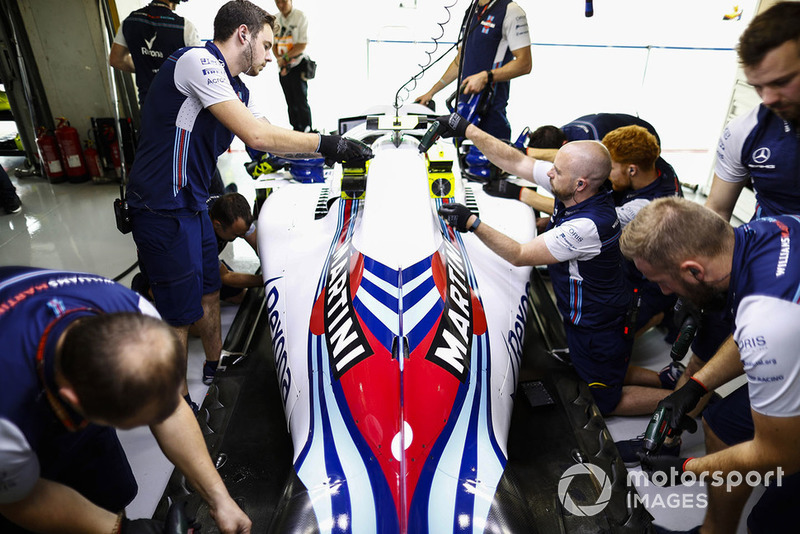 Team members work on the car of Sergey Sirotkin, Williams FW41, in the garage