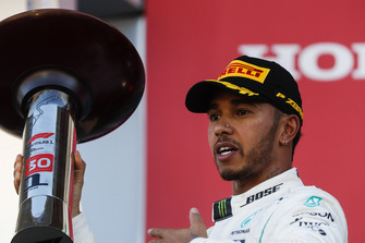 Race winner Lewis Hamilton, Mercedes AMG F1, celebrates with his trophy on the podium