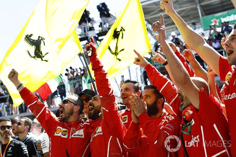 Ferrari team members celebrate at the podium