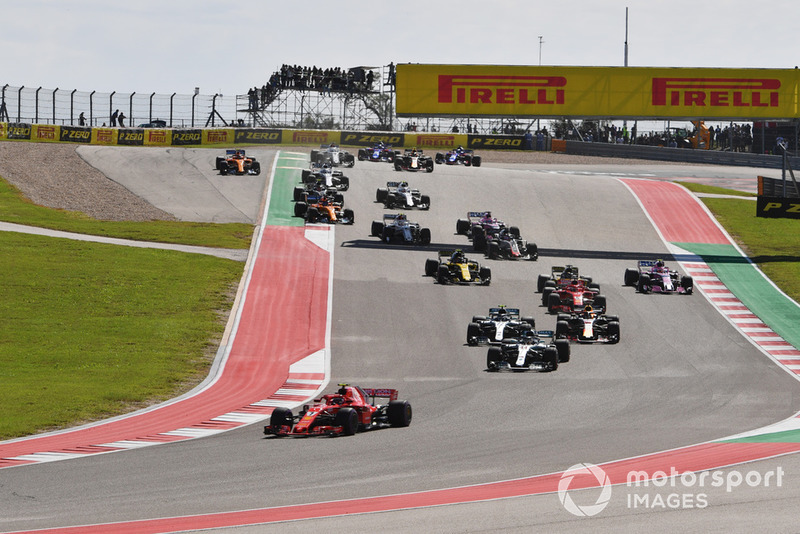 Kimi Raikkonen, Ferrari SF71H and Lewis Hamilton, Mercedes-AMG F1 W09 leads at the start of the race