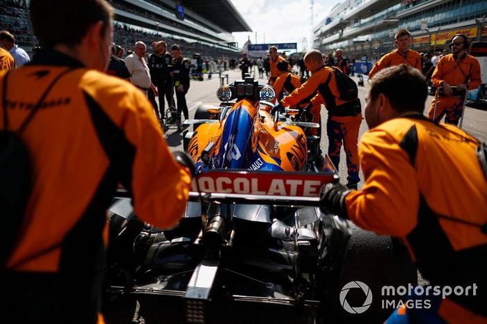 Carlos Sainz Jr, McLaren, llega a la parrilla con sus mecánicos