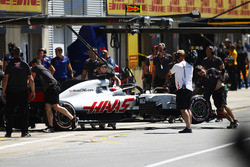 Romain Grosjean, Haas F1 Team, is pushed into his garage after his car started smoking in qualifying