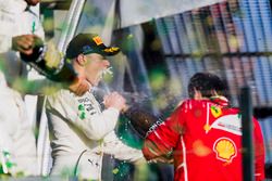 Lewis Hamilton, Mercedes AMG, 2nd Position, Valtteri Bottas, Mercedes AMG, 3rd Position, and Sebastian Vettel, Ferrari, 1st Position, spray Champagne on the podium