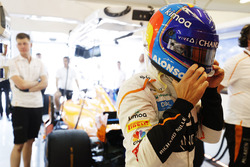 Fernando Alonso, McLaren, puts on his helmet in the garage
