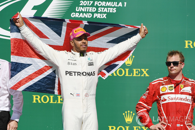 Race winner Lewis Hamilton, Mercedes AMG F1 celebrates on the podium with the union flag and Kimi Raikkonen, Ferrari