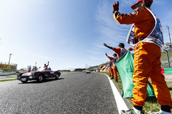 Marshals line the track as Sebastian Vettel, Ferrari, passes in the drivers parade