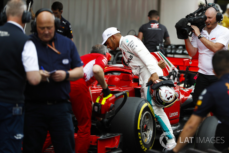 Lewis Hamilton, Mercedes AMG F1, studies the Kimi Raikkonen Ferrari after qualifying