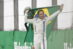Felipe Massa, Williams, carries a Brazilian flag as he walks back to his garage in tears after crash