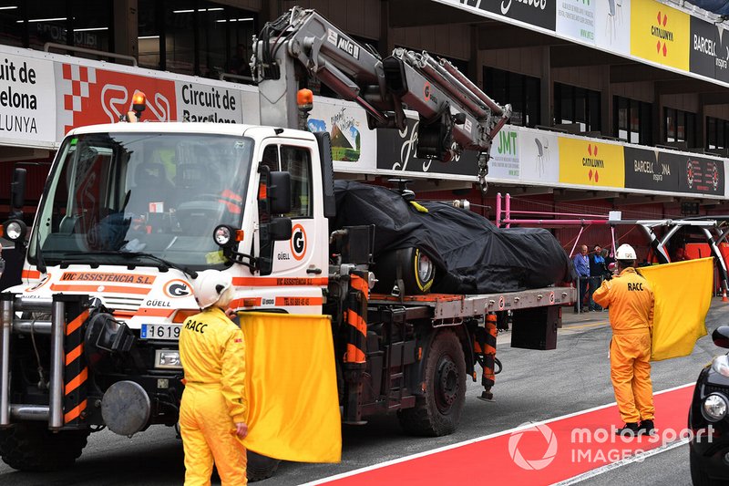 The car of Romain Grosjean, Haas F1 Team VF-19 is recovered to the pits