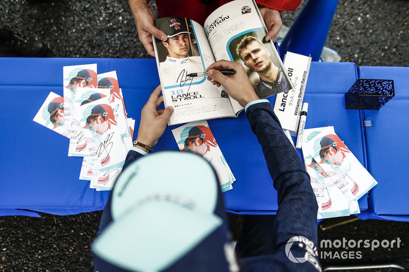 Lance Stroll, Williams Racing, signs an autograph for a fan