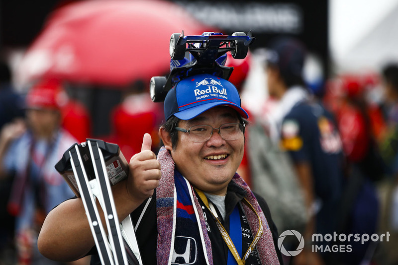 A fan with a Toro Rosso model car hat
