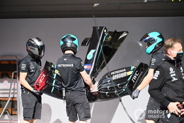 Miembros del equipo Mercedes trabajan en el coche