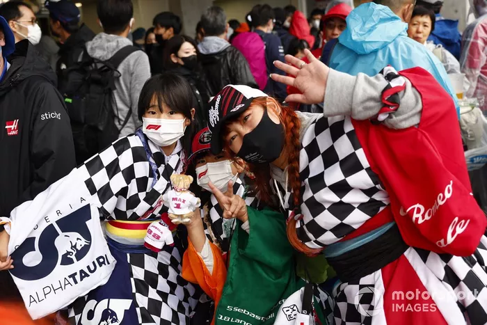 Fans in chequered flag outfits